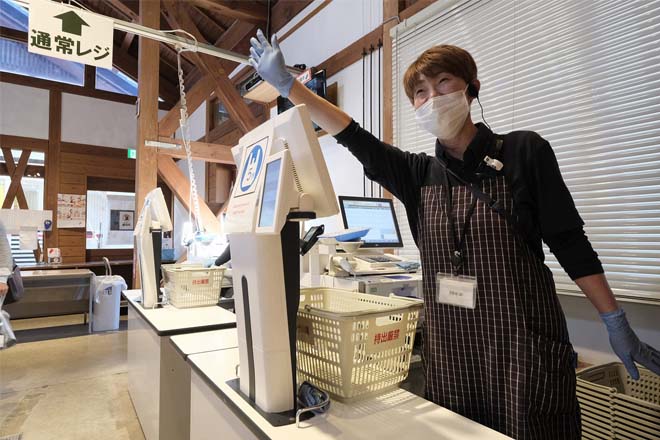 レジスタッフが手を挙げているのイメージ