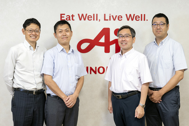 味の素の男性社員が4名並んでいるイメージ