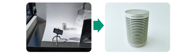 カウンターに並ぶお酒の瓶、テーブルに置かれた花、手書きのメニューボード